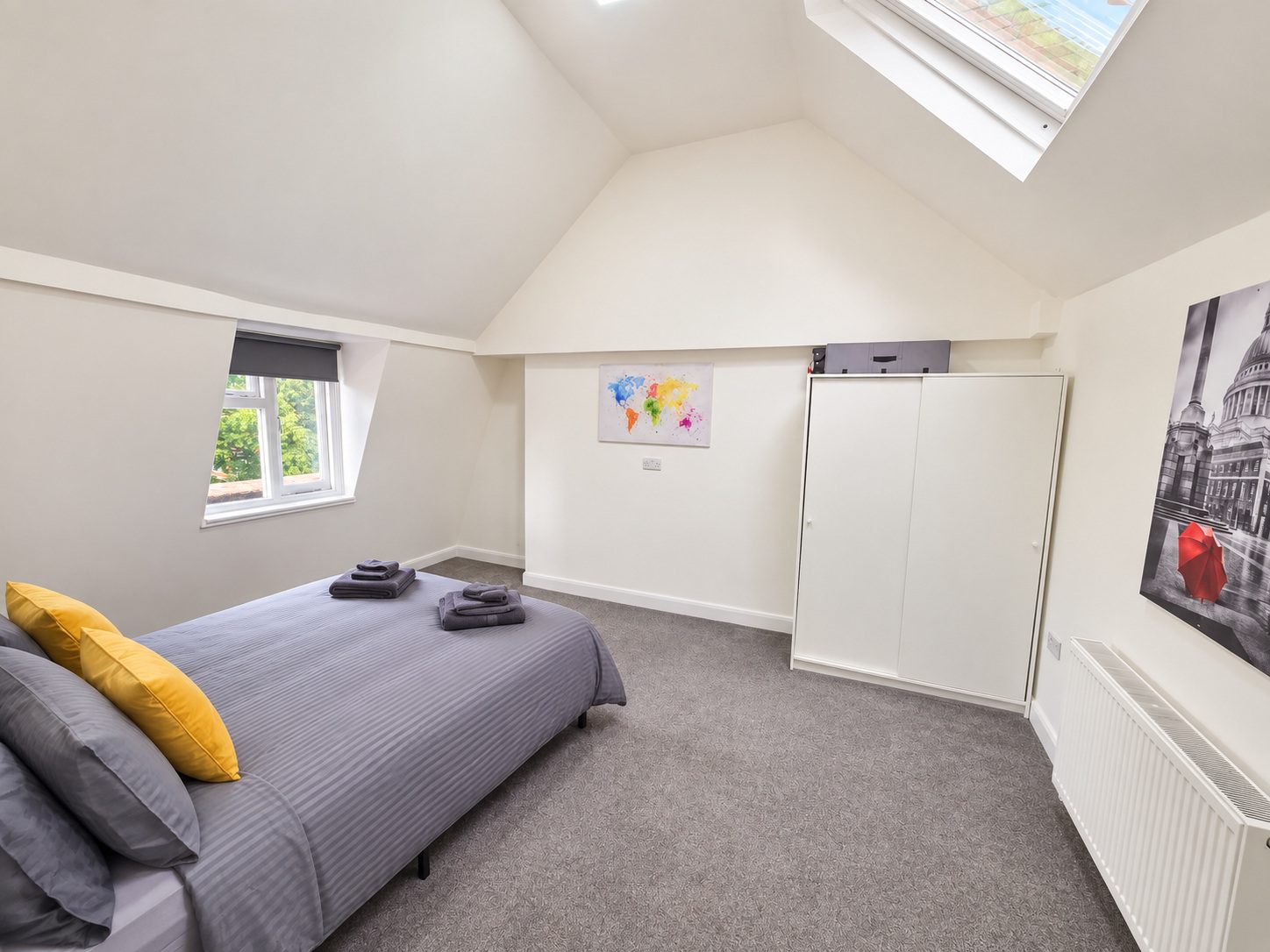 Bedroom with skylight and wardrobe
