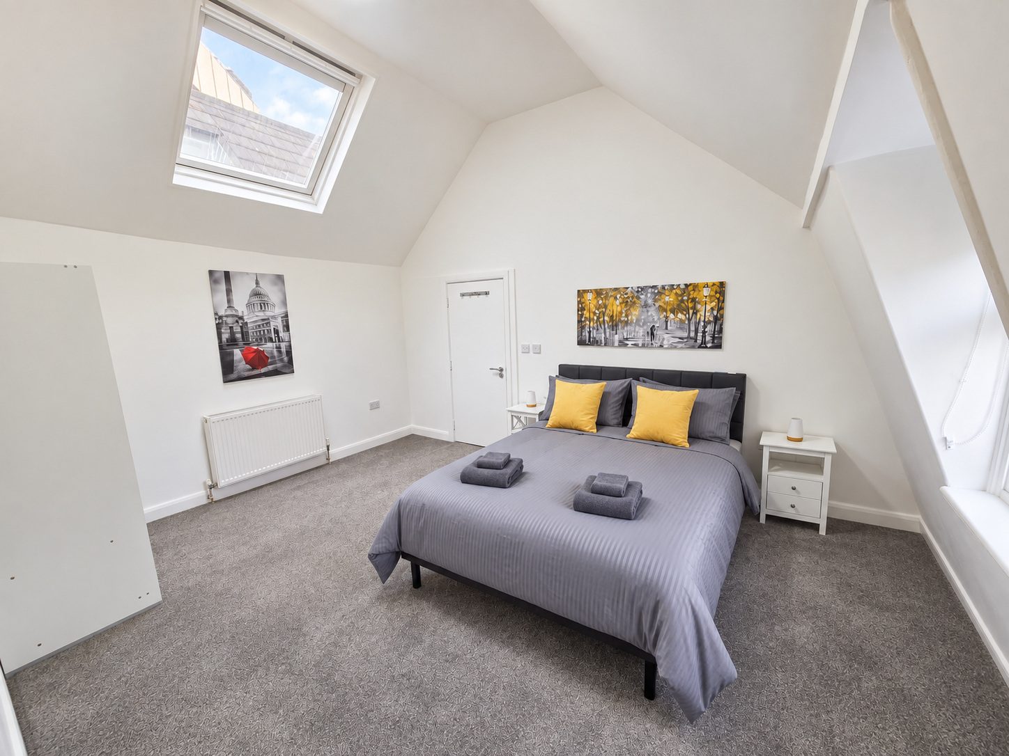 Main bedroom with vaulted ceiling and skylight
